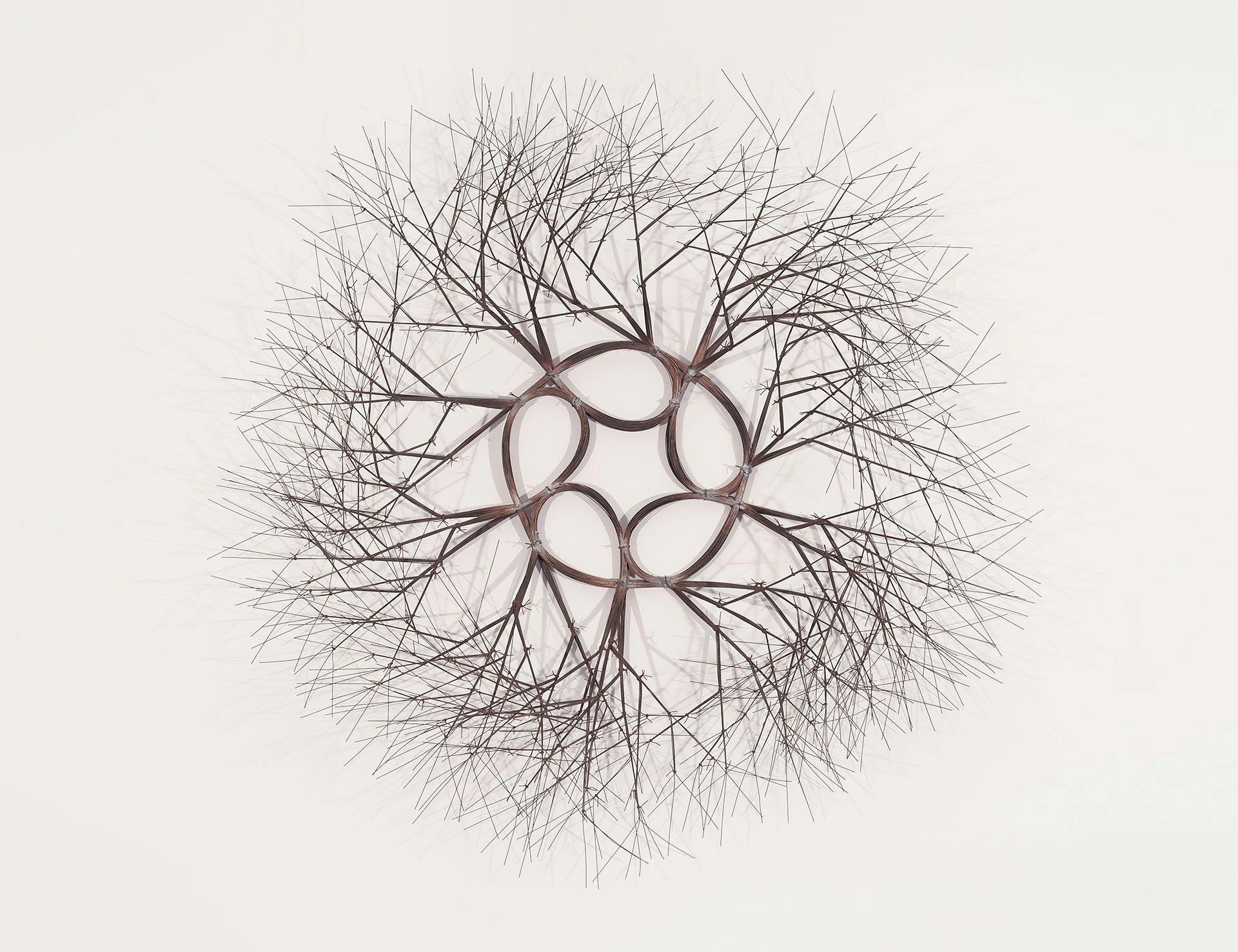 A wall-hanging wire sculpture by Ruth Asawa, titled Sun and Star (S.616/60), circa 1966.